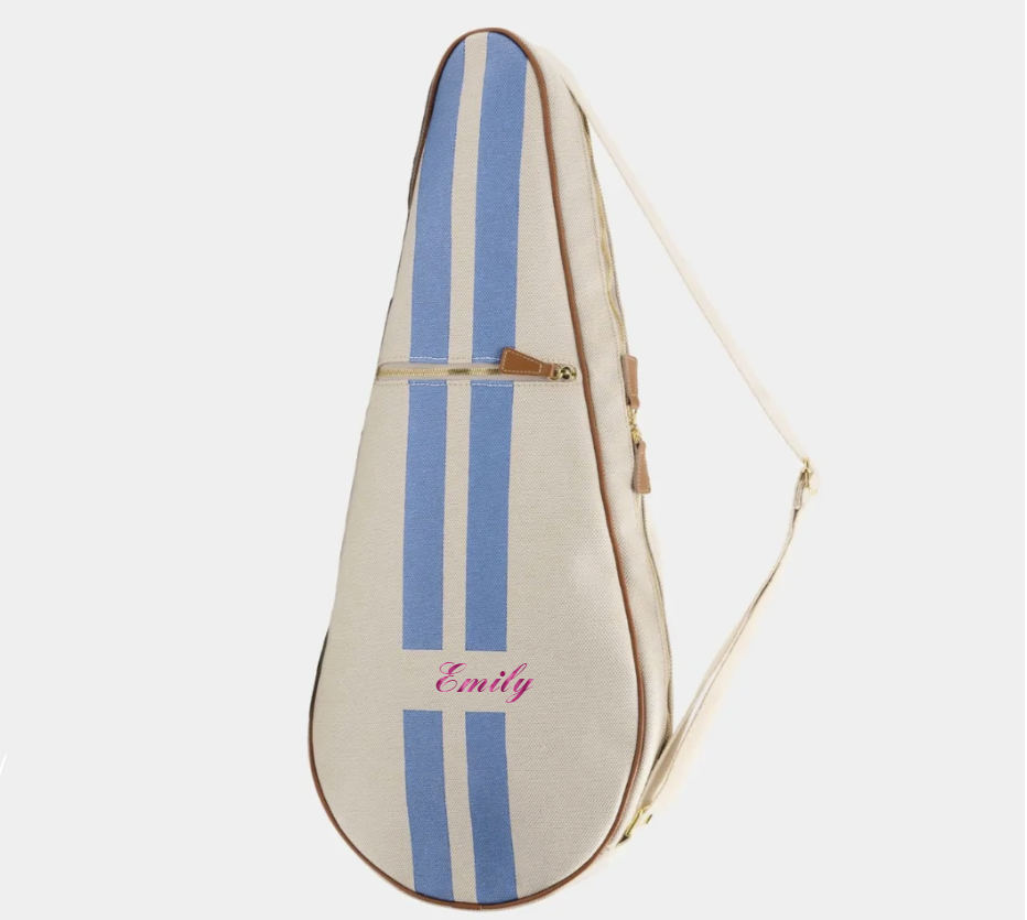 A personalized guitar case in cream canvas with two vertical blue stripes, a pink embroidered name 'Emily', and a brown leather zipper pull, shown on a light gray background.